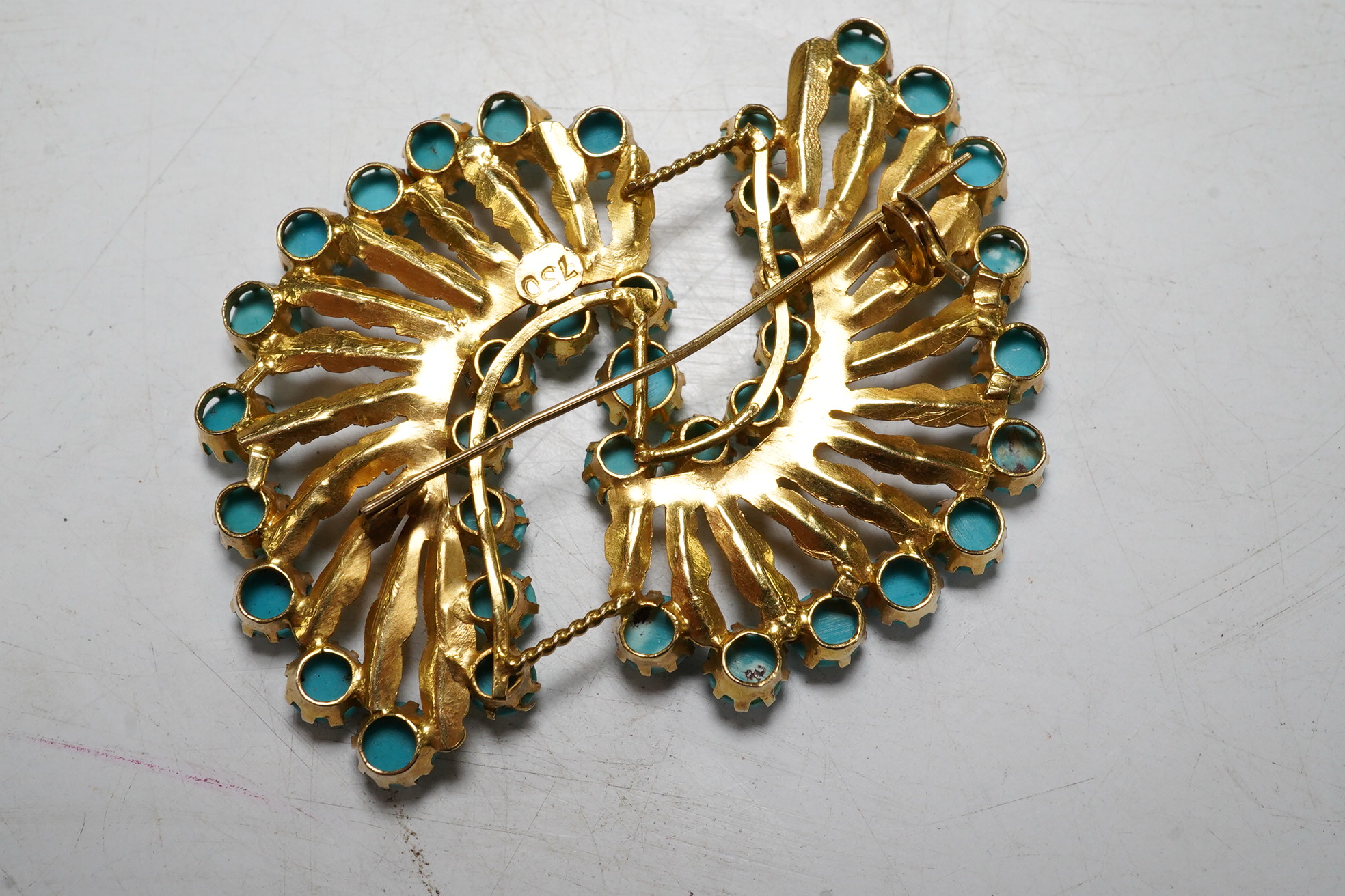 An 18ct gold and turquoise dress ring, gross 7.3 grams, and a turquoise set brooch stamped 750, gross 10.5 grams Condition - fair.